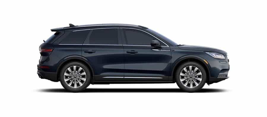 Side view of a sleek, dark blue SUV with tinted windows and alloy wheels.
