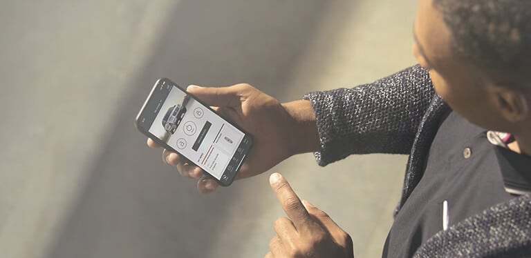 User checking the Lincoln app on a smartphone