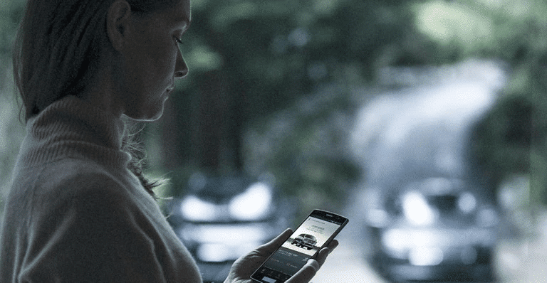 Person using a smartphone to contact Lincoln service.