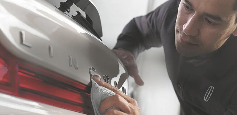 Lincoln technician performing vehicle maintenance