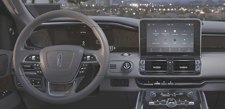 Interior of a Lincoln vehicle showing steering wheel and dashboard
