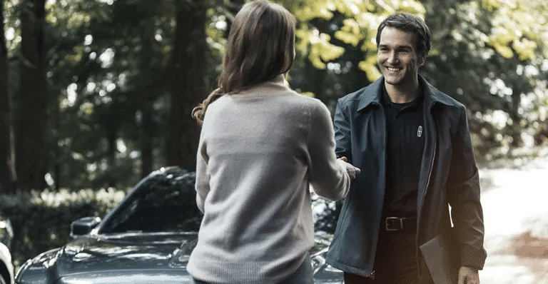 Customer handing over vehicle keys to a Lincoln service representative.